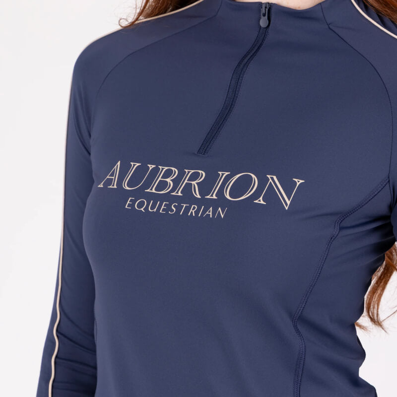 Person in an Aubrion Equestrian Long Sleeve Baselayer Midnight with a zip collar.