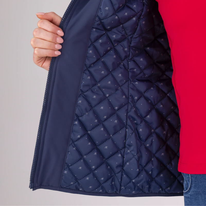 Someone holds open an Aubrion Equestrian Gilet Midnight, showing off its inner lining.
