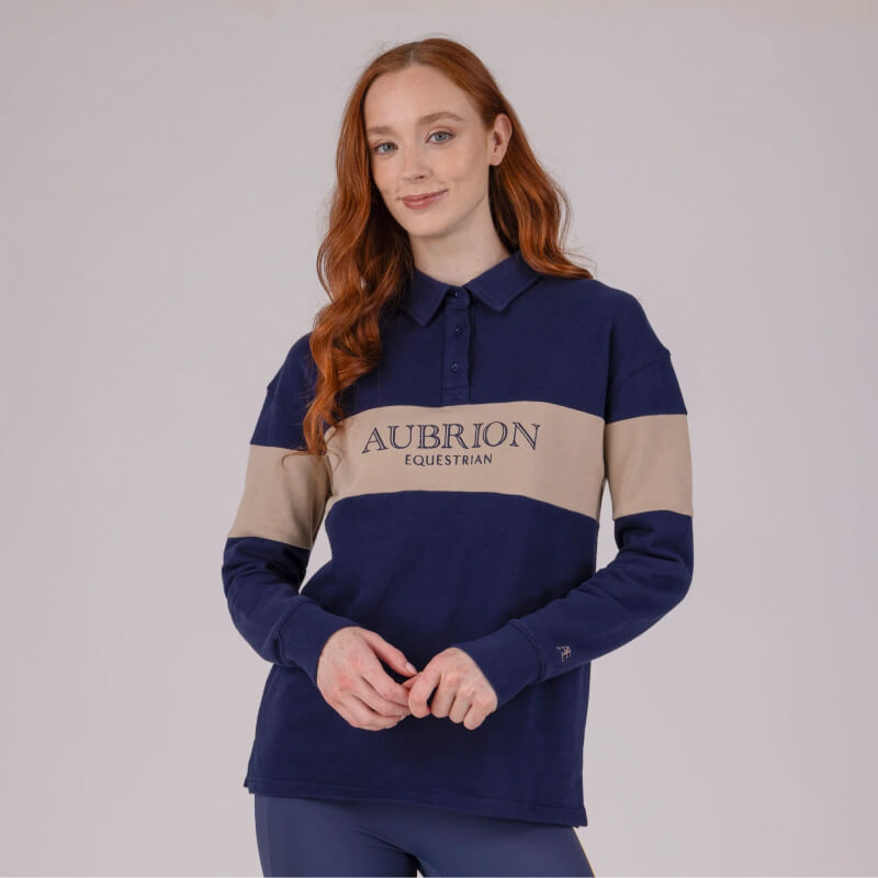 Woman in an Aubrion Equestrian Button Sweatshirt, Midnight/Taupe.