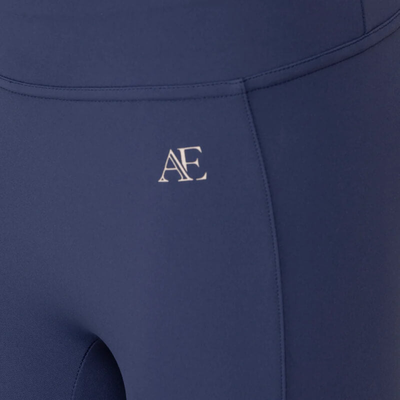 Close-up of Aubrion Equestrian Young Rider Riding Tights Midnight with a white left hip AE logo.