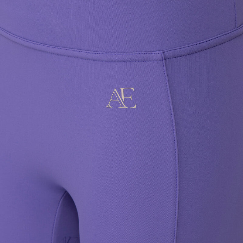 Close-up of Aubrion Equestrian Young Rider Riding Tights Heather with logo near the hip.