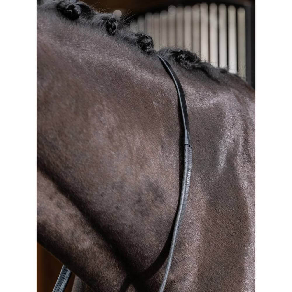 Close-up of a dark brown horse’s neck with braided mane and LeMieux Rubber Reins in Black.