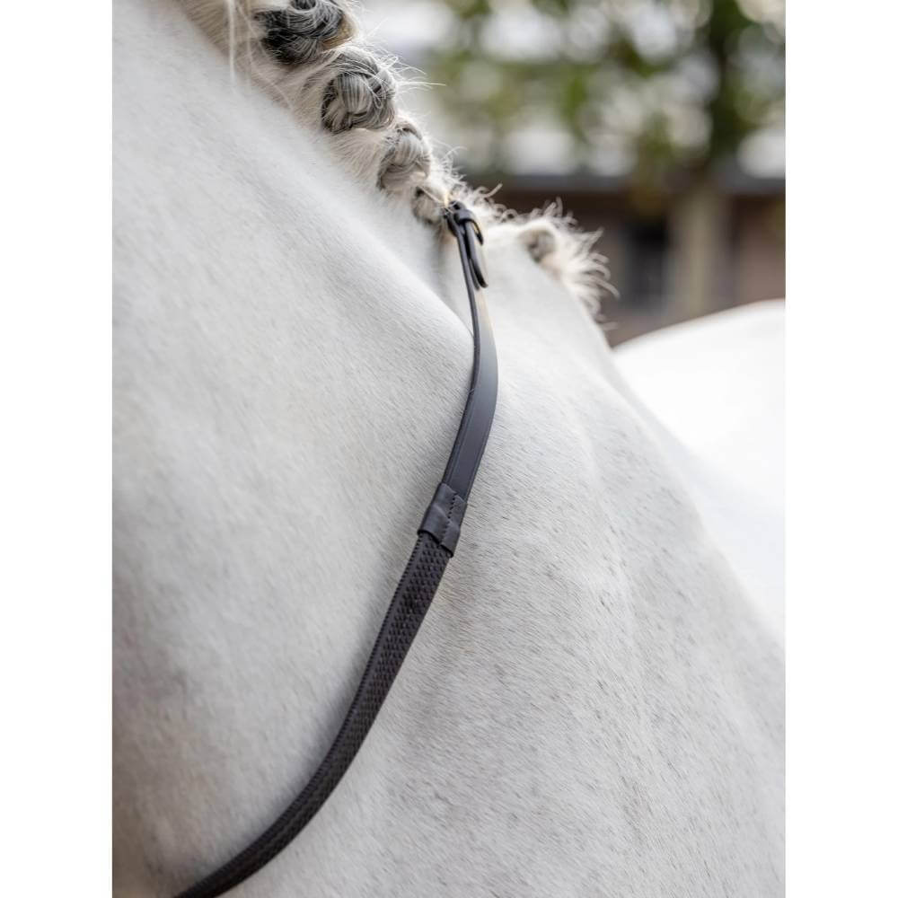 Close-up of a braided mane on a white horse with LeMieux Rubber Reins Brown over its neck.