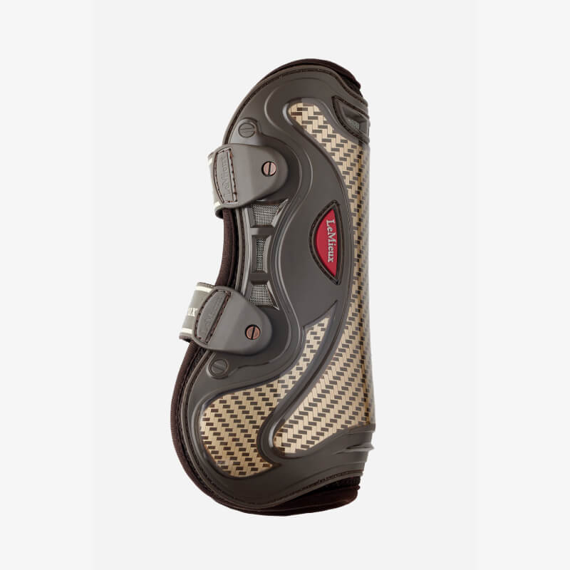 Close-up of horse's legs in LeMieux Exo-Flex Tendon Boot Brown/Gold for outdoor tendon protection.