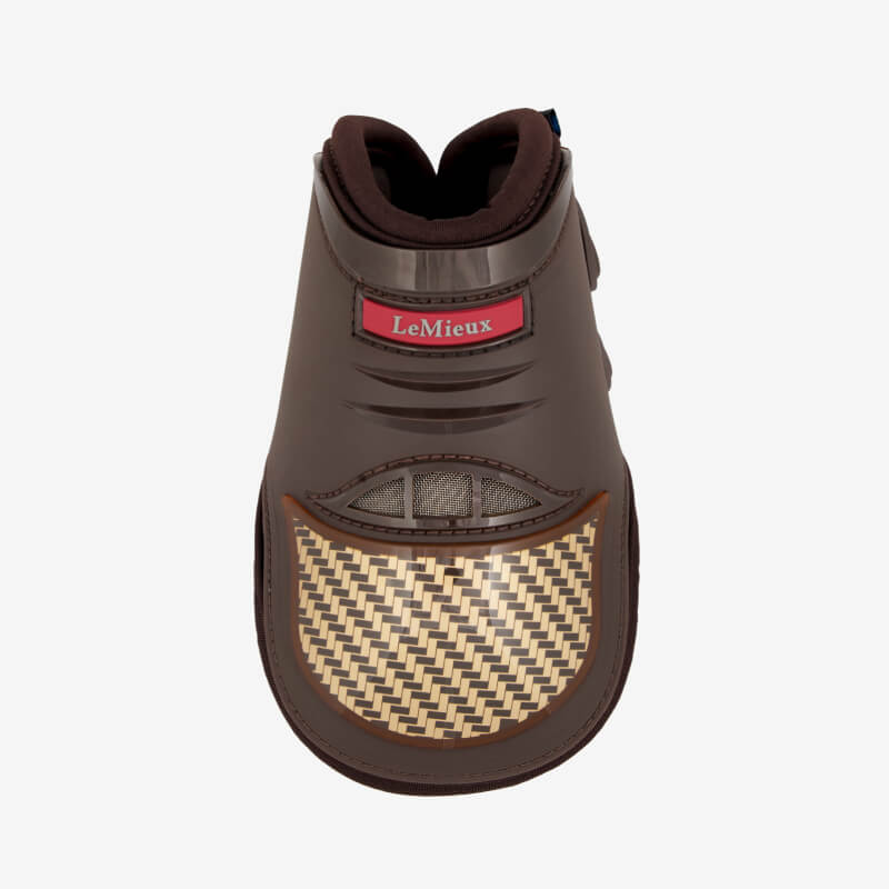 Close-up of horse's leg wearing LeMieux Exo-Flex Fetlock Boot Brown/Gold for tendon protection.