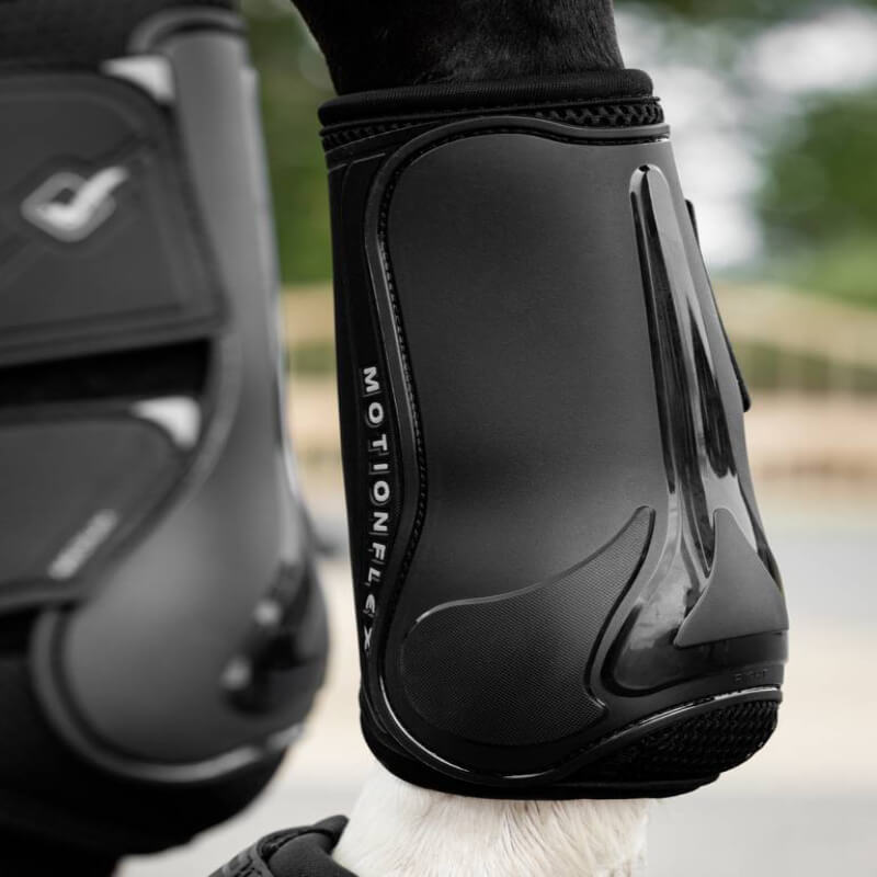 Close-up of LeMieux Motion Flex Dressage Boot Black with secure straps for horse leg protection.