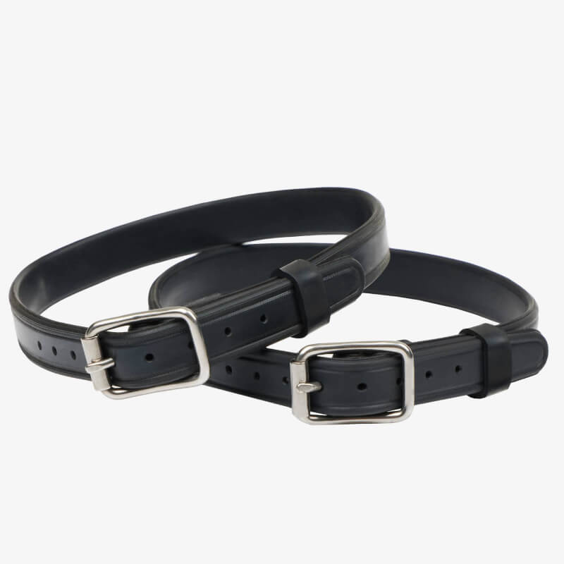 A person fastens LeMieux Spur Straps Black by LeMieux to their riding boots.