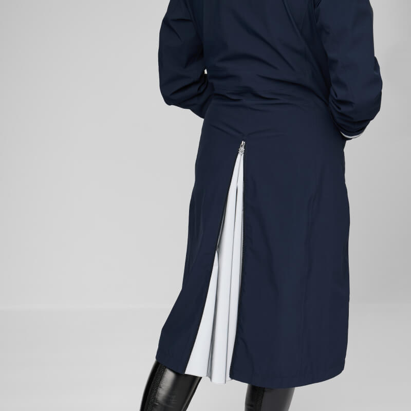 Wearing a LeMieux Amelie Lightweight Riding Coat in navy with black pants.