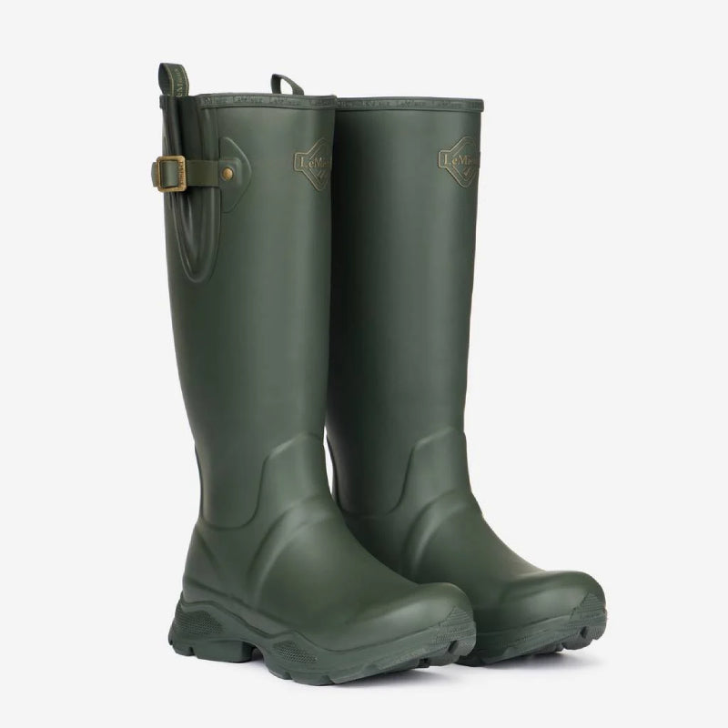 LeMieux Stride Wellington Boot Oak: tall green boots with gold buckle strap and chunky sole.