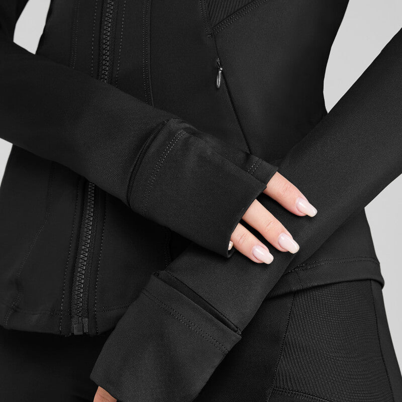 Woman in Aztec Diamond Core Fitted Jacket Black, light pink nails, hands crossed.