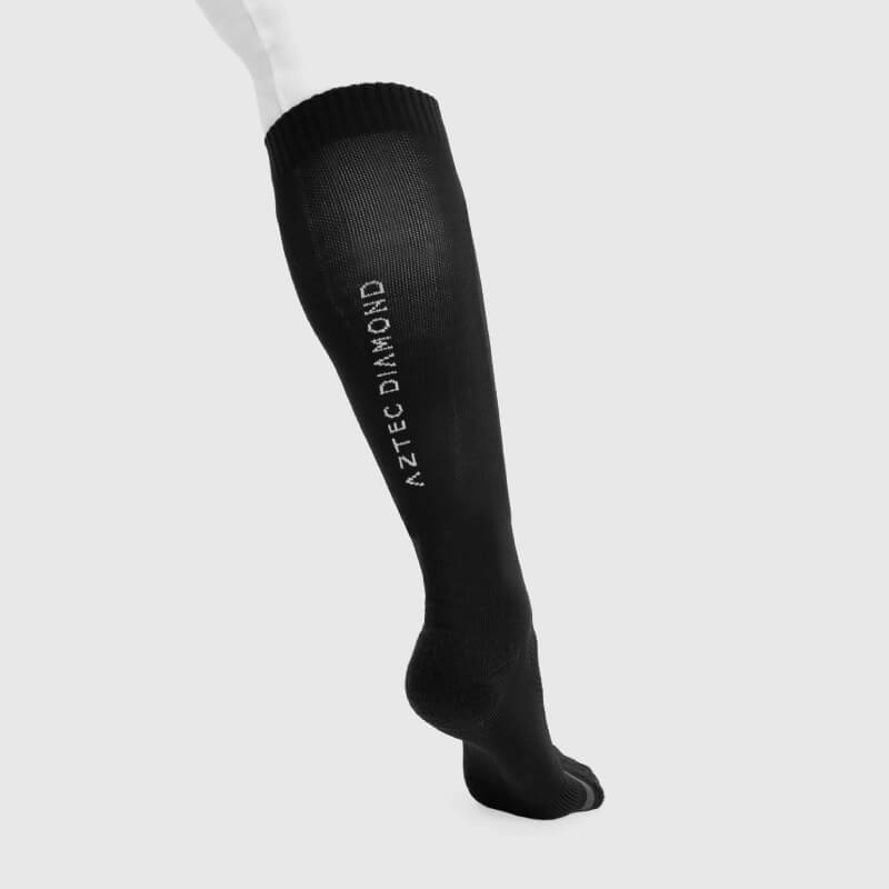 Black Aztec Diamond Technical Sock on mannequin leg, brand name in white vertically.