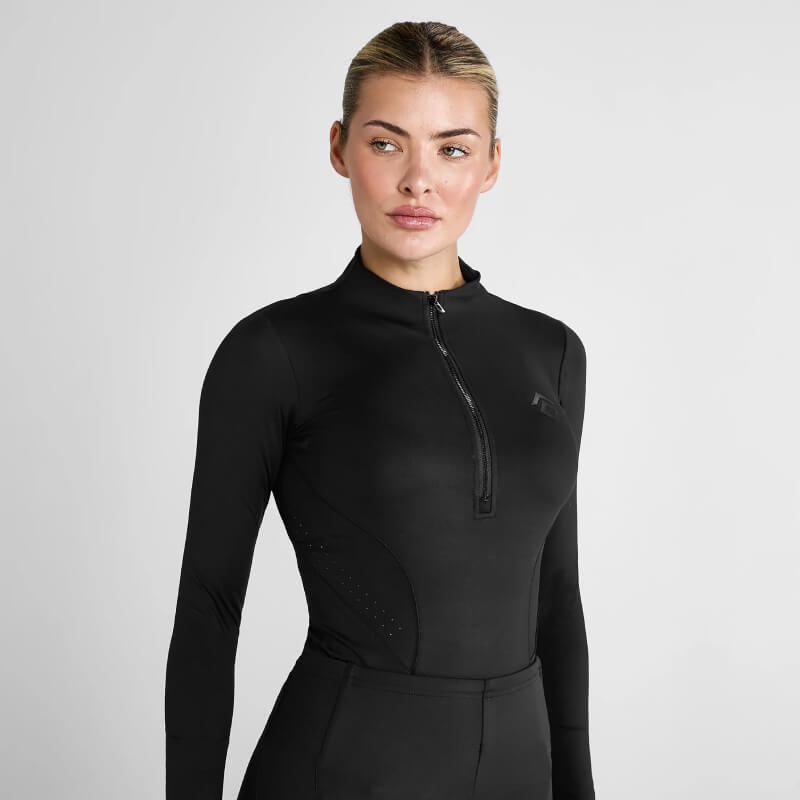 Woman in Aztec Diamond Core Baselayer Black, premium sports fabric, against plain background.