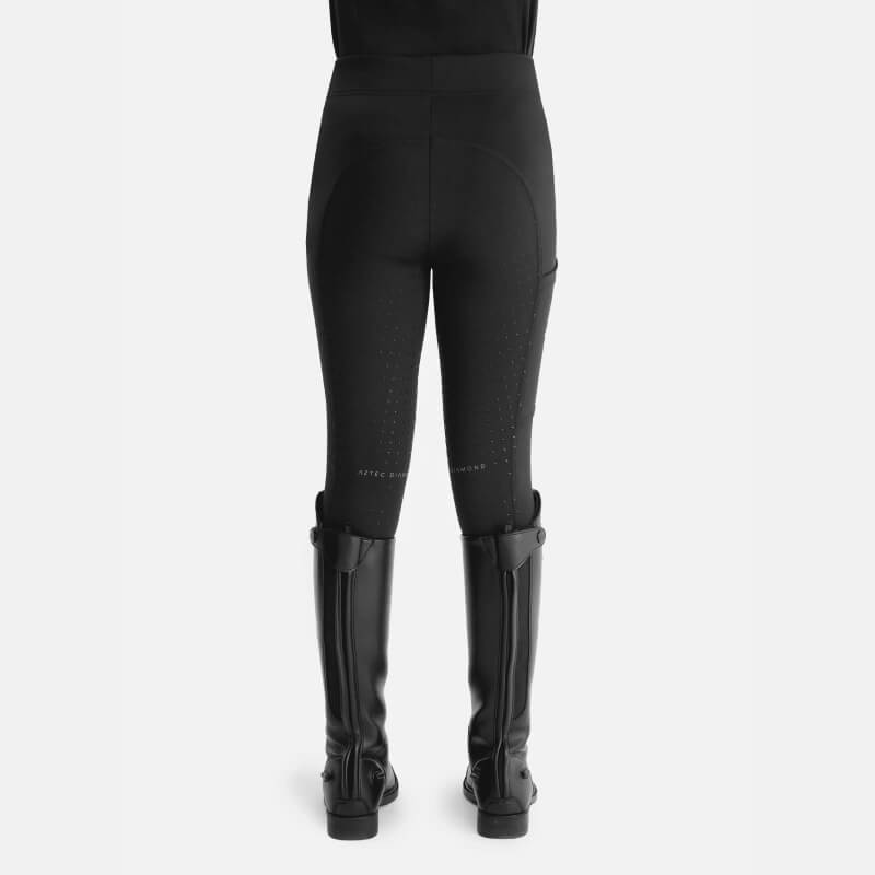 Model in Aztec Diamond YR Full Seat Leggings Black and tall boots, shown from the back on white.