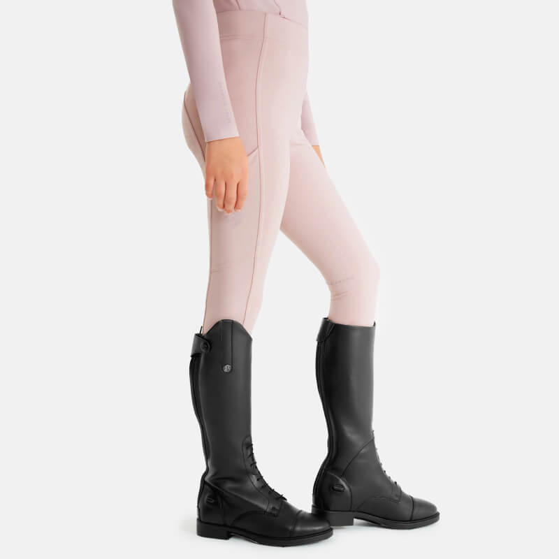 Person in Aztec Diamond YR Full Seat Leggings Pink and black tall boots, standing sideways.