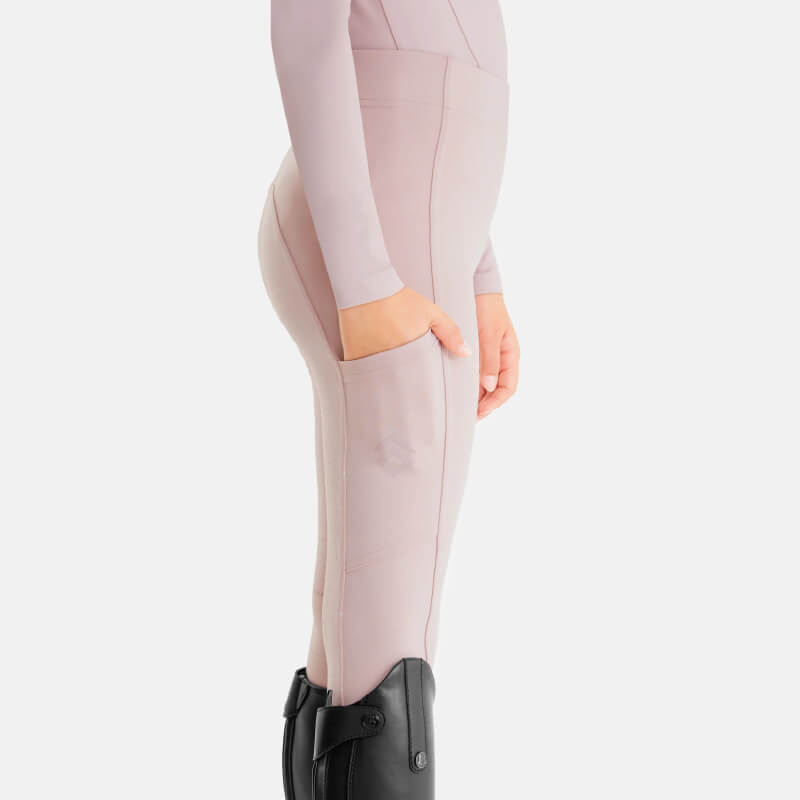 Person in Aztec Diamond YR Full Seat Leggings Pink, black boots, hand in pocket, side view.