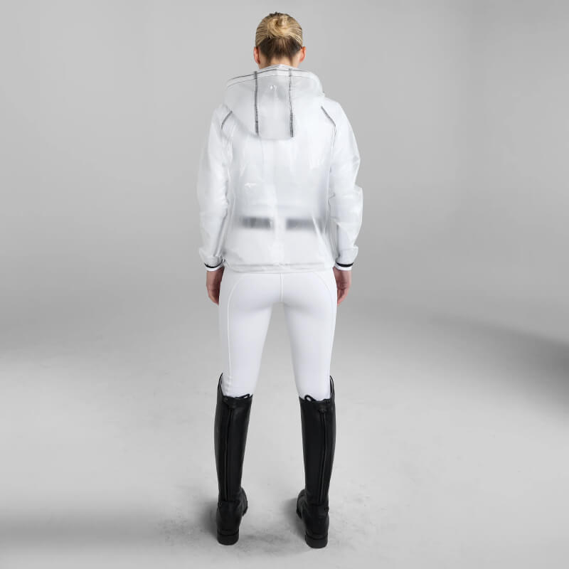 Person in Aztec Diamond Rain Jacket Clear, black boots, facing away in a white studio.