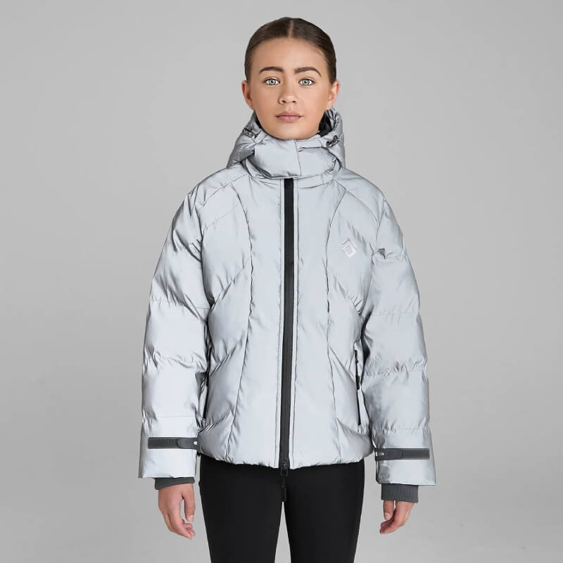 Woman in Aztec Diamond YR Puffer Coat Reflective stands against a plain gray background.