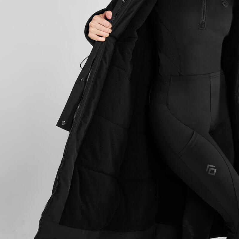 Woman wears Aztec Diamond Black Fleece Lined Rain Jacket against plain gray background.