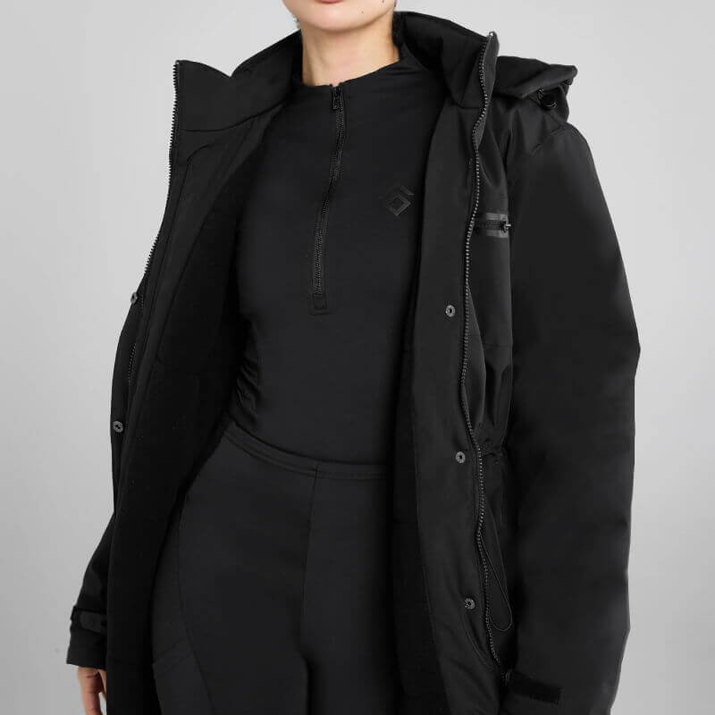 Person wears Aztec Diamond Black Fleece Lined Rain Jacket and black pants, shoulders to thighs.