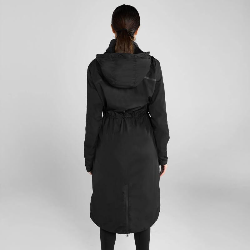Woman wears Aztec Diamond Lightweight Rain Jacket Black against a plain gray background.