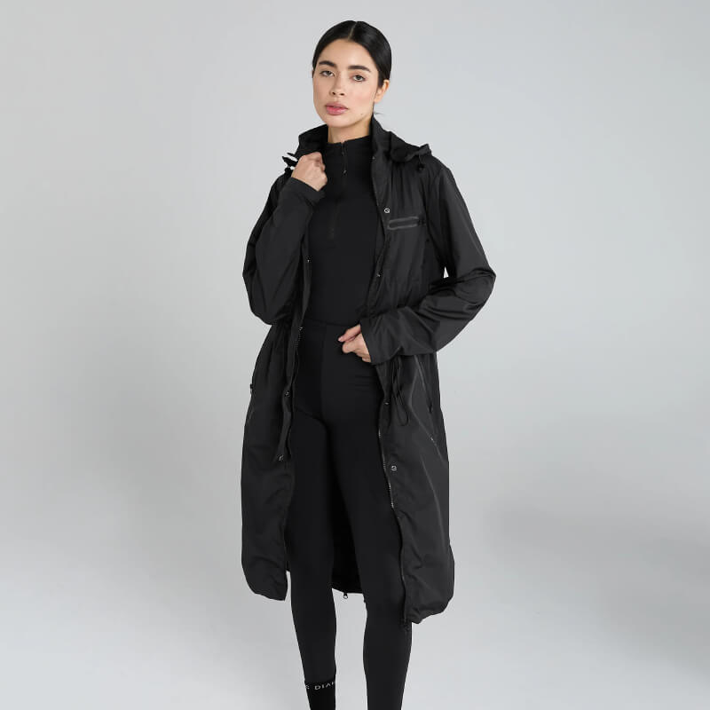 Woman wears Aztec Diamond Lightweight Rain Jacket Black against a plain gray background.