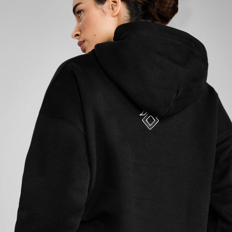 Woman wearing Aztec Diamond EQ Club Pull on Hoodie Black, white square back design, facing away.