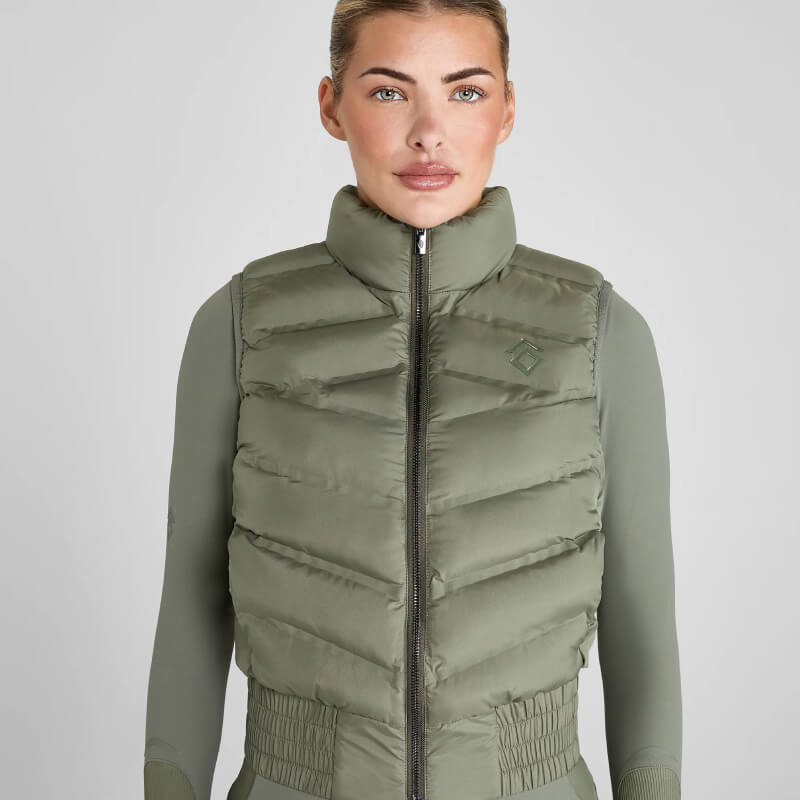 Woman wears Aztec Diamond Lightweight Gilet in Sage with matching long-sleeve top, facing forward.
