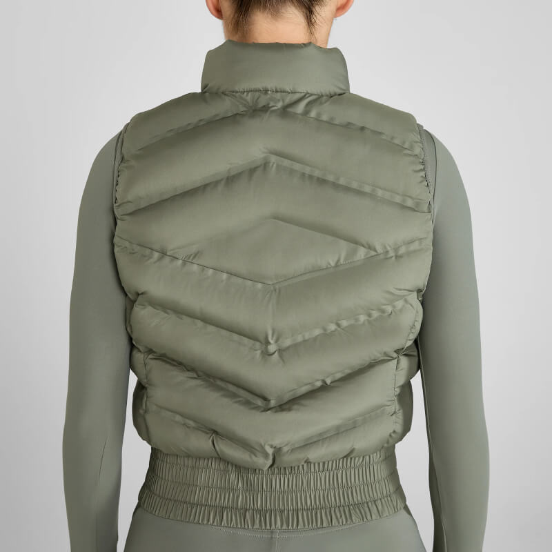 Person wearing Aztec Diamond Lightweight Gilet Sage and matching fitted outfit, shown from the back.