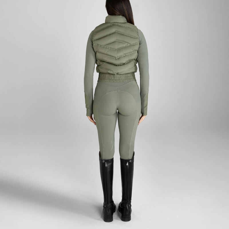 Woman in Aztec Diamond Define Leggings Knee Grip Sage and black boots stands on plain background.