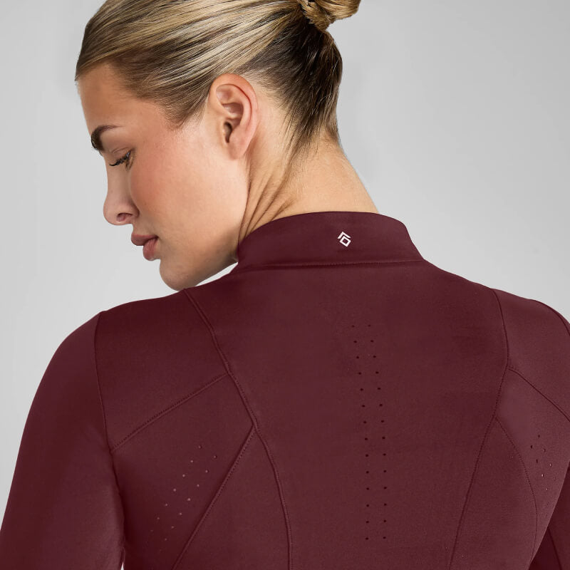 Blonde woman in a bun wears Aztec Diamond Core Baselayer Cherry, shown from the back.