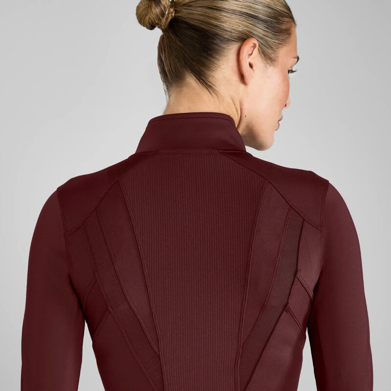 Blonde woman in a bun wearing the Aztec Diamond Core Fitted Jacket in Cherry.