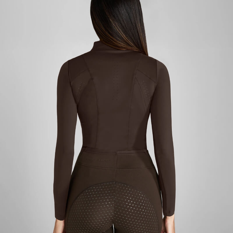 Woman with long brown hair in Aztec Diamond Core Baselayer Mocha, shown from behind.