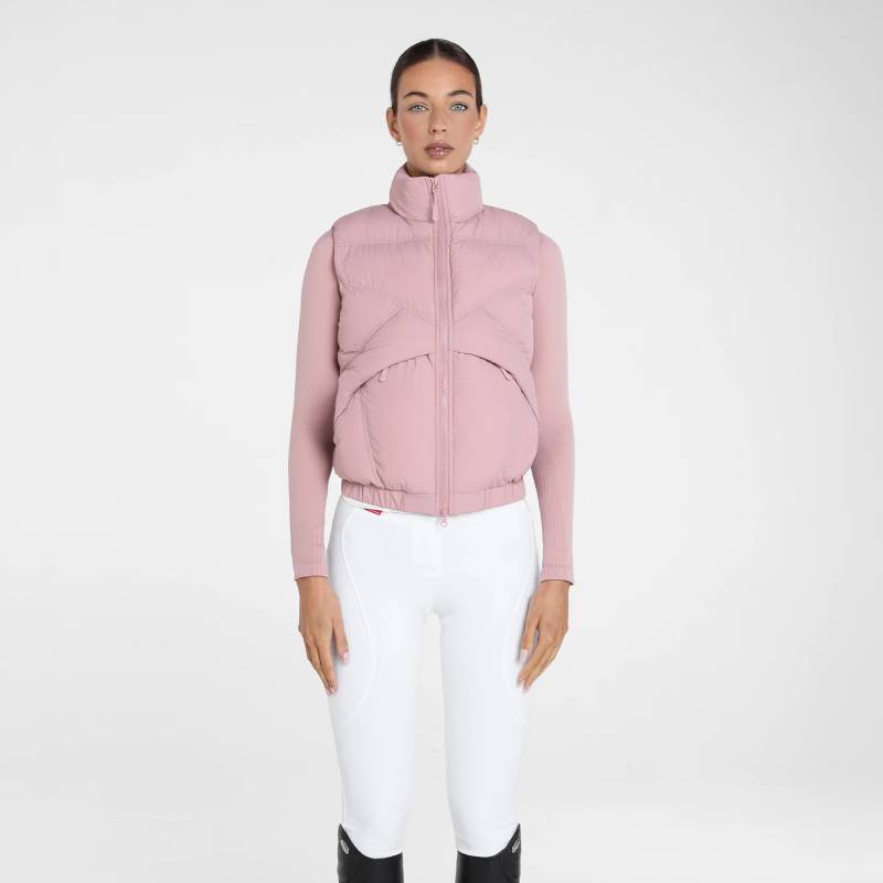 Person in Aztec Diamond Pink Core Mid-layer Gilet, arms crossed, white pants, on white background.