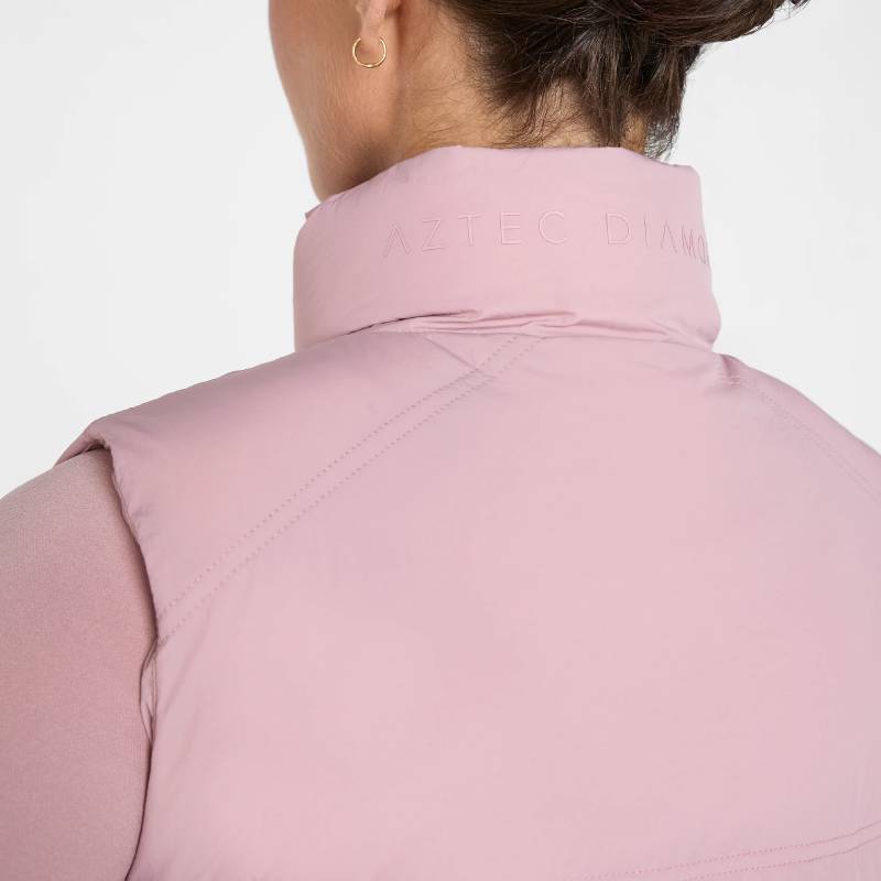Person in Aztec Diamond Pink Core Mid-layer Gilet with logo text on collar, seen from behind.