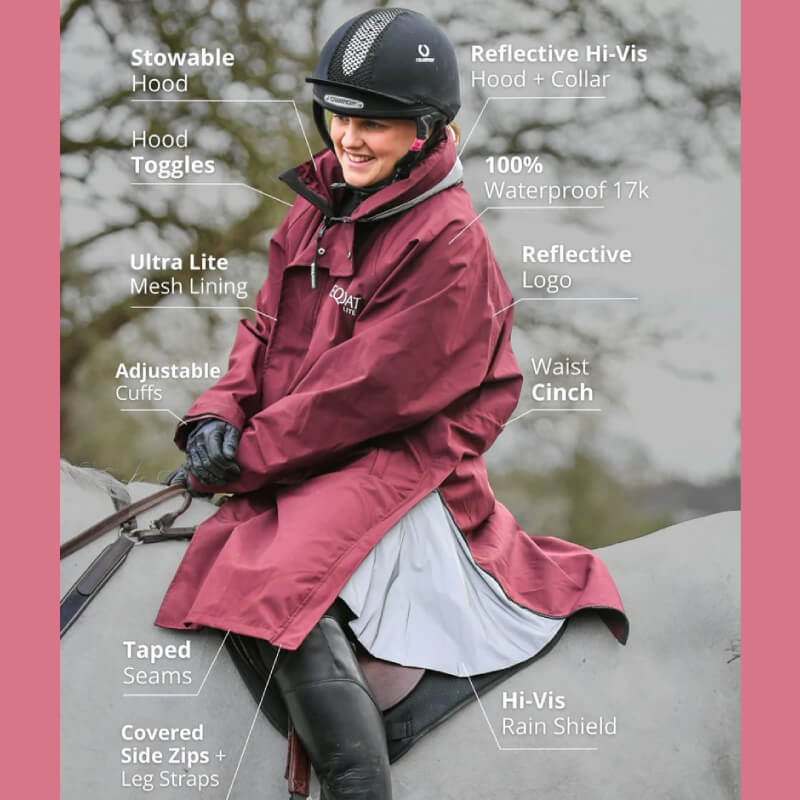 Smiling rider in Reinwear Reincoat Lite Adult Burgundy with labeled features.
