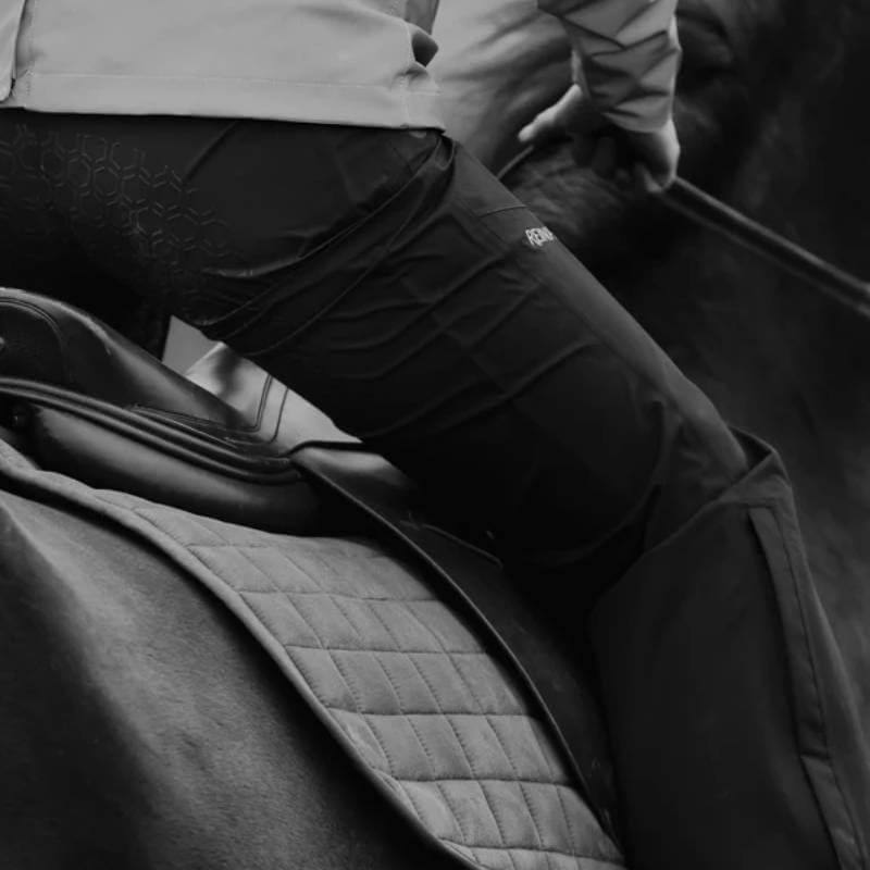 Reinwear Reinpants Lite Black: Breathable, waterproof pants shown with rider’s leg and saddle.