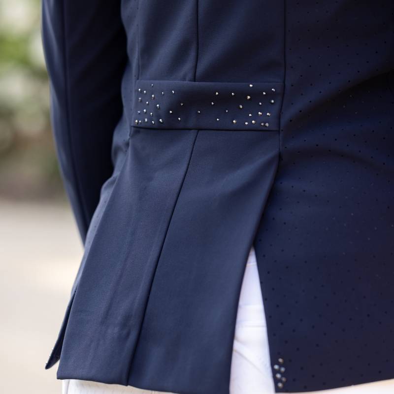 Close-up of the LeMieux Junior Pro Show Jacket Navy, styled with white pants.