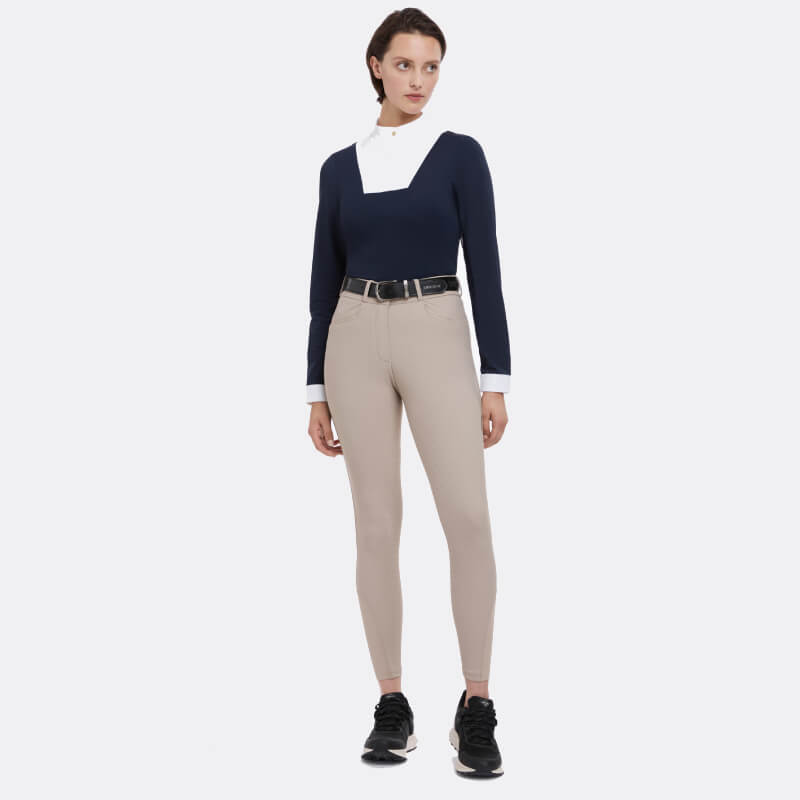 Person in LeMieux Isabelle Full Seat Breeches Almond, black sneakers, and a navy long-sleeve top.