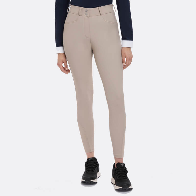Person in LeMieux Isabelle Full Seat Breeches Almond, black sneakers, and a navy long-sleeve top.