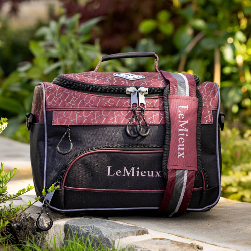 LeMieux Elite ProKit Lite Grooming Bag in Burgundy with adjustable strap and zippered pockets.