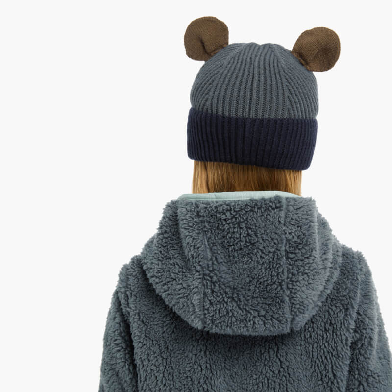 Person in a LeMieux Mini Bear Beanie Petrol and gray fuzzy hoodie, seen from behind.