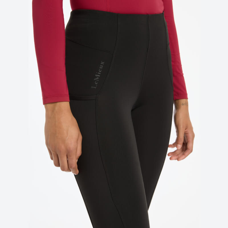 Wearing LeMieux Naomi Pull On Breeches Full Seat Black against a white background.