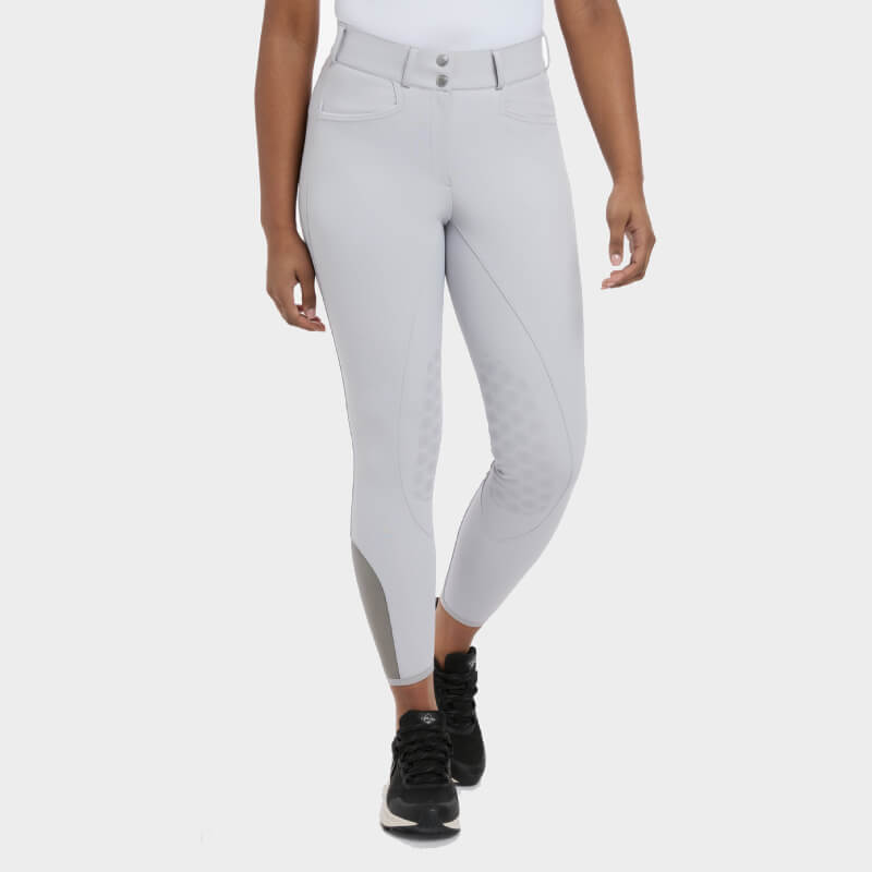 Wearing LeMieux Imogen Knee Grip Breech Light Grey with black shoes against a white background.