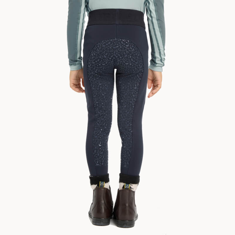 Child wearing LeMieux Mini Pull Ons Navy, top, and boots, shown from behind.