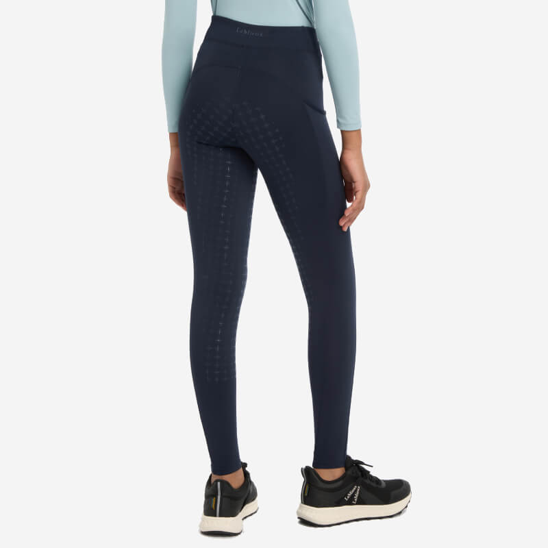 Model wears LeMieux Young Rider Orla Pull Ons Navy with full seat silicone grip, rear view.