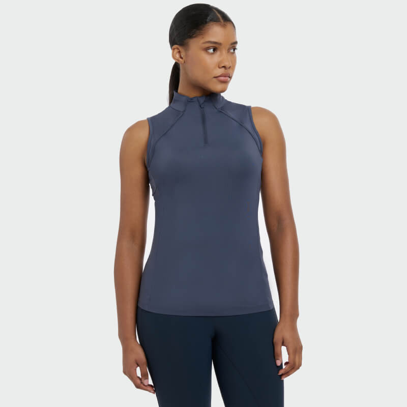 Woman in LeMieux Maria Mesh Sleeveless Baselayer Dusk Blue, UV50+ fabric.