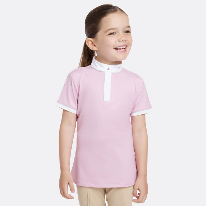 Young girl in Lemieux Mini Bella Show Shirt Blossom by LeMieux, standing and looking left.