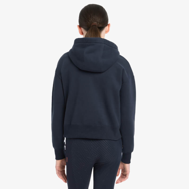Person wearing LeMieux Young Rider Hettie Half Zip Hoodie Navy and dark pants, back view.