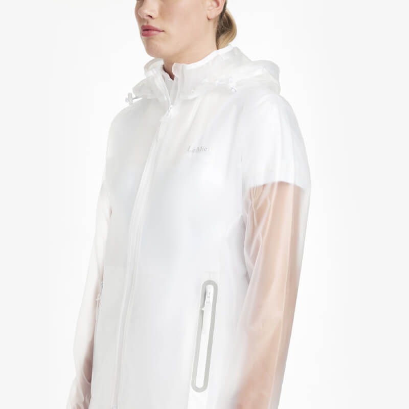 Wearing a LeMieux Competition Waterproof Jacket Clear with mesh sleeves and white pants.