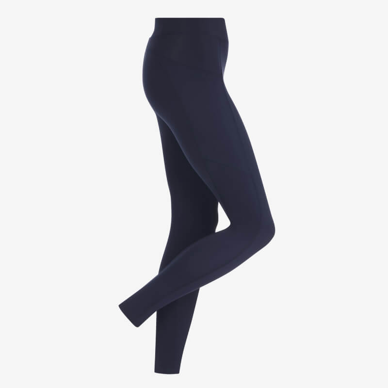 LeMieux Dani Sport Legging Navy shown on a model standing sideways with legs crossed.